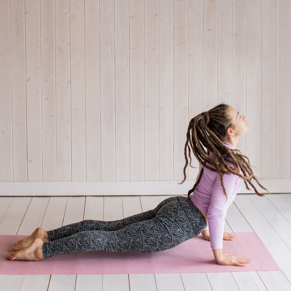 Person feeling energetic and stretching upwards in a bright, clean space.